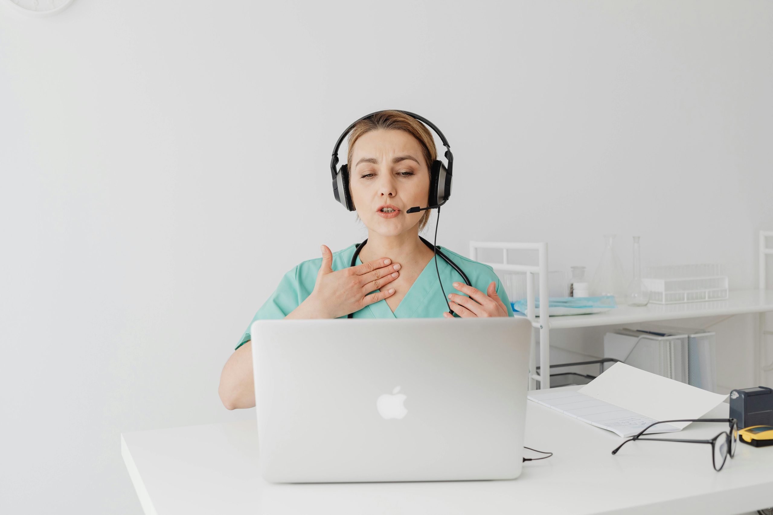 Telehealth doctor helping patient on computer